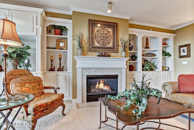 living area with a fireplace, ornamental molding, and built in features