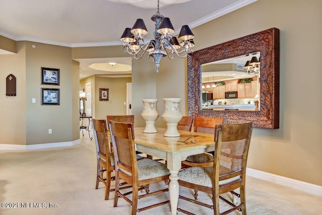 dining area with ornamental molding, a chandelier, light carpet, and baseboards