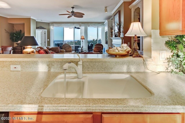 kitchen featuring open floor plan, light countertops, and a sink