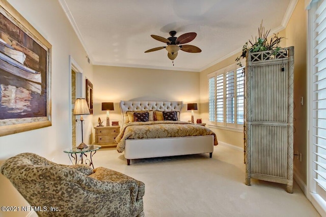 carpeted bedroom with ornamental molding, a ceiling fan, and baseboards