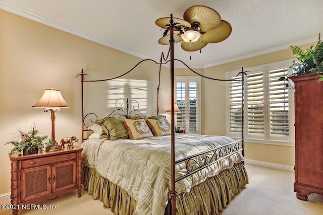 bedroom featuring baseboards, ornamental molding, and light colored carpet