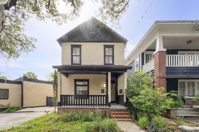 view of front of house with a porch and stucco siding