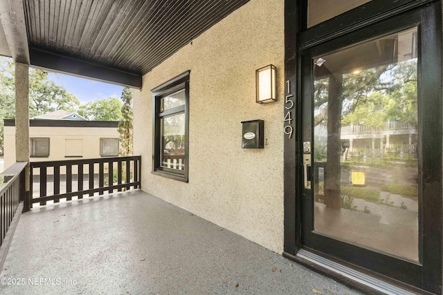 exterior space with elevator and stucco siding