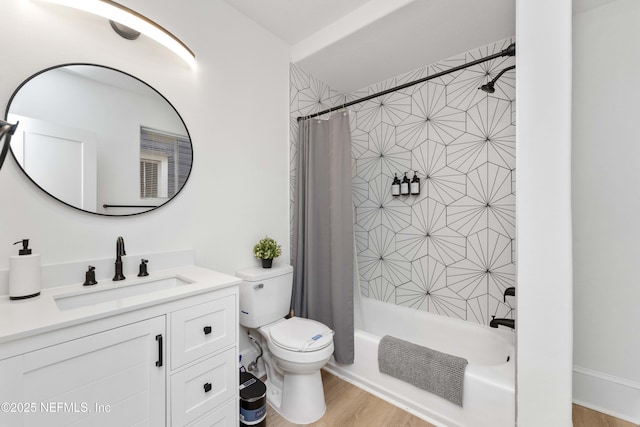 bathroom featuring toilet, shower / bath combo with shower curtain, wood finished floors, and vanity