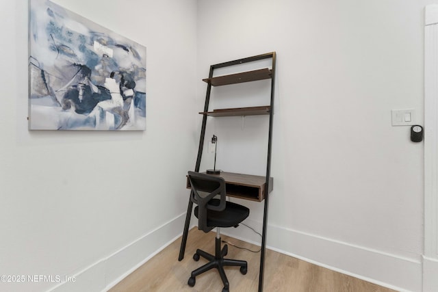 office area featuring baseboards and wood finished floors