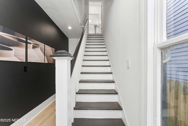 stairs featuring baseboards