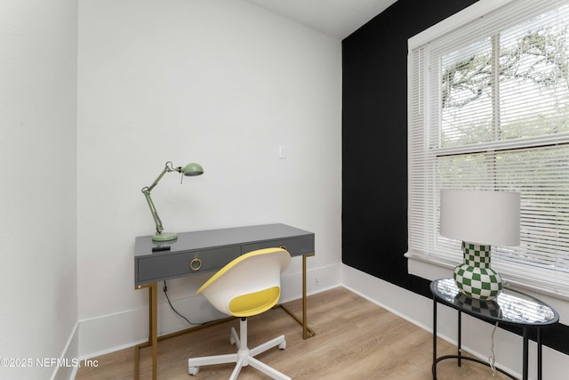 home office featuring baseboards and wood finished floors