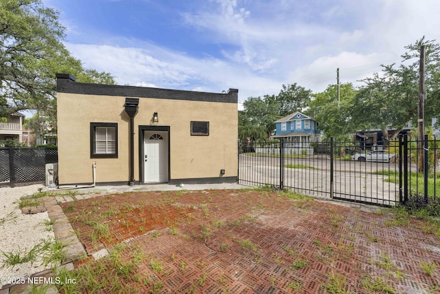 view of front of home featuring fence and stucco siding