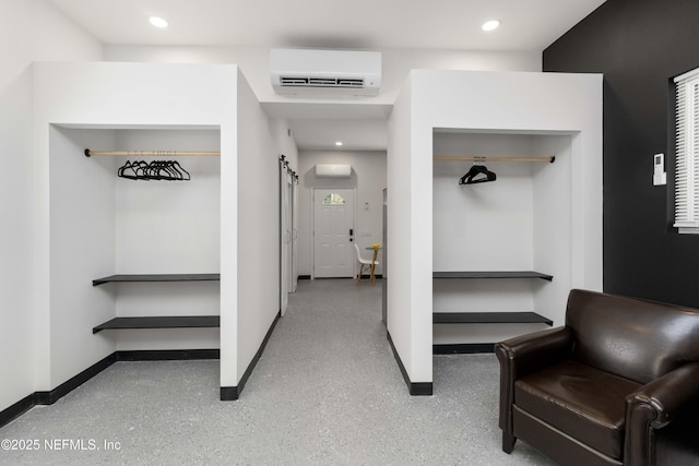 mudroom with a barn door, baseboards, a wall unit AC, speckled floor, and recessed lighting