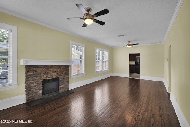 unfurnished living room featuring dark wood-type flooring, a fireplace, a wealth of natural light, and crown molding