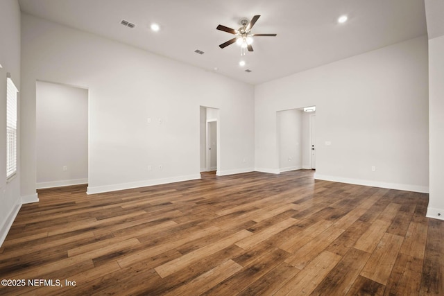 empty room featuring a ceiling fan, recessed lighting, dark wood finished floors, and baseboards