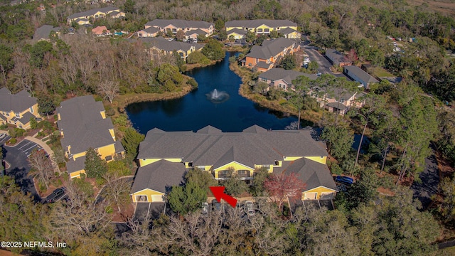 drone / aerial view featuring a residential view and a water view