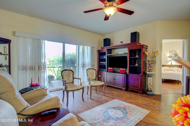 living area featuring ceiling fan and wood finished floors