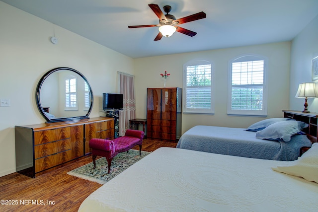 bedroom featuring wood finished floors and a ceiling fan