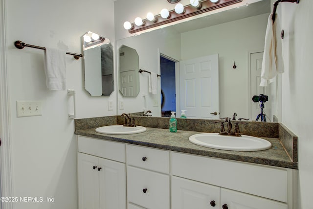 bathroom with double vanity and a sink