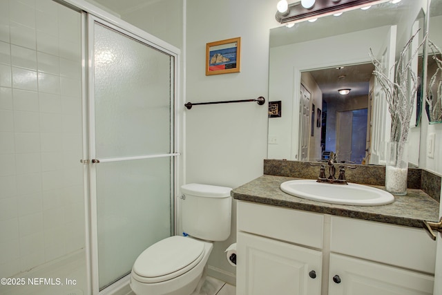 full bath with a stall shower, vanity, and toilet