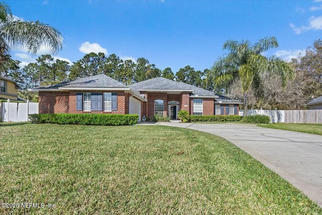 ranch-style home with driveway, brick siding, a front yard, and fence