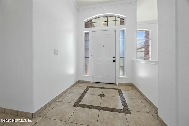 foyer entrance featuring crown molding, plenty of natural light, and baseboards