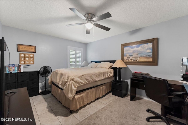 bedroom featuring light tile patterned flooring, ceiling fan, a textured ceiling, and baseboards