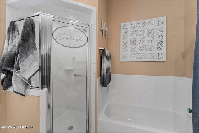 bathroom with a garden tub and a shower stall