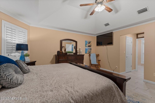 bedroom featuring baseboards, visible vents, lofted ceiling, ornamental molding, and wood finished floors