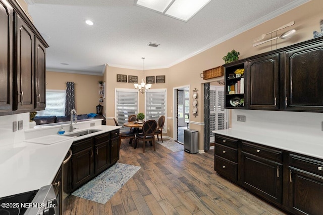 kitchen with dark wood-style flooring, open shelves, light countertops, ornamental molding, and a sink