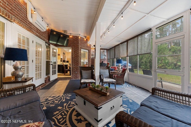 sunroom / solarium with a wall mounted air conditioner and rail lighting