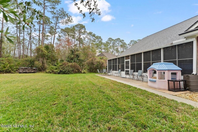 view of yard with a sunroom and a patio