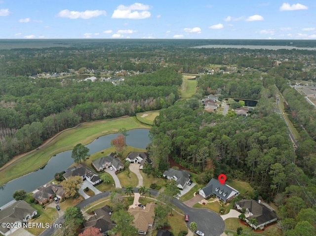 aerial view featuring a water view and a wooded view