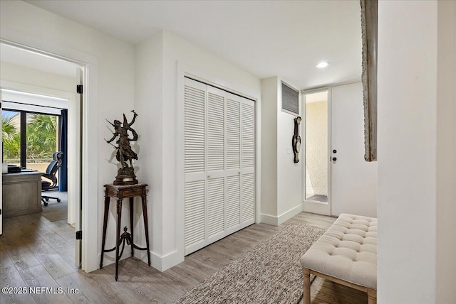 hall featuring visible vents, recessed lighting, wood finished floors, and baseboards