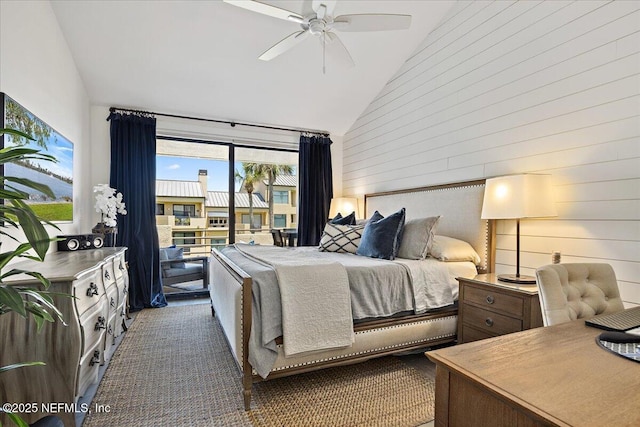 bedroom featuring wooden walls, high vaulted ceiling, ceiling fan, and dark carpet