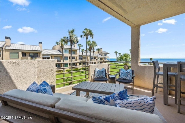 view of patio / terrace featuring an outdoor hangout area, a balcony, and a water view