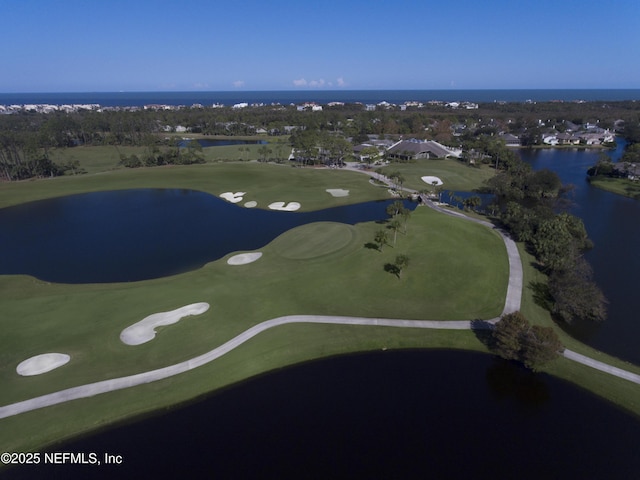 birds eye view of property featuring golf course view and a water view