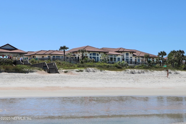 exterior space with fence and a water view