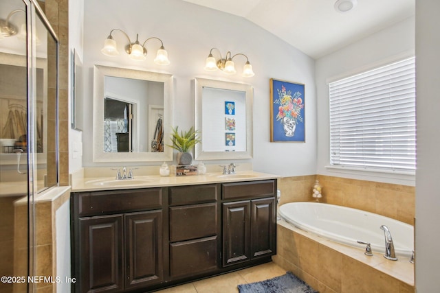 full bathroom featuring lofted ceiling, a garden tub, a sink, and a shower stall