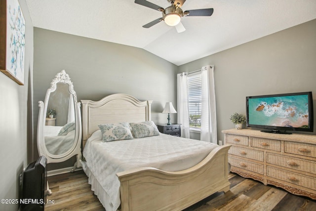 bedroom with vaulted ceiling, wood finished floors, and a ceiling fan