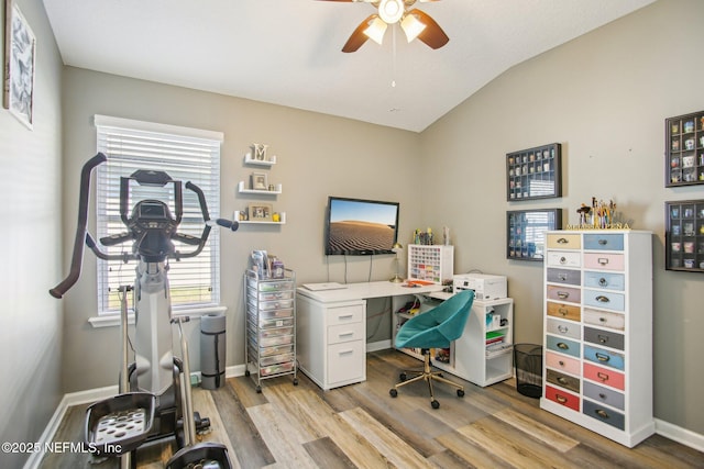 office space with ceiling fan, light wood finished floors, vaulted ceiling, and baseboards