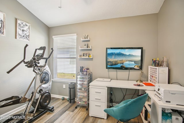 office space with light wood-style flooring and baseboards