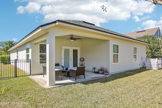 rear view of property with french doors, a patio area, fence, and a lawn