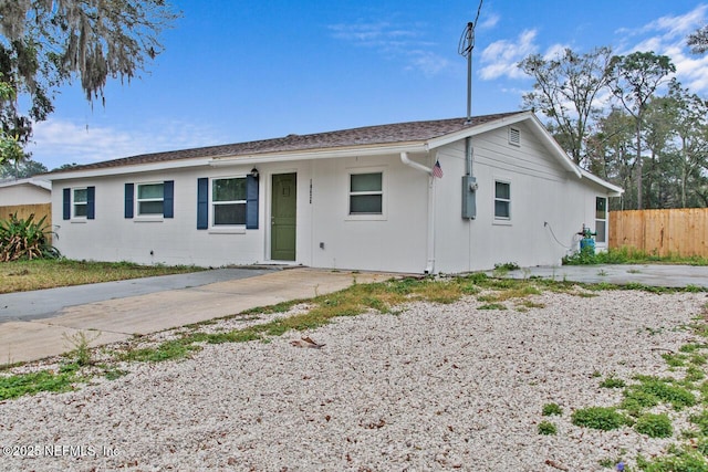 ranch-style home with fence