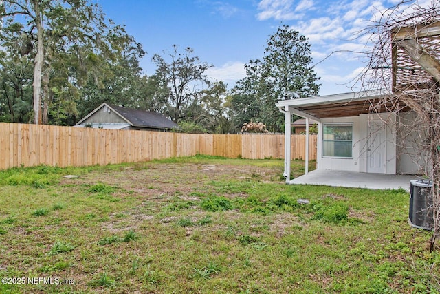 view of yard featuring a fenced backyard, central AC unit, and a patio