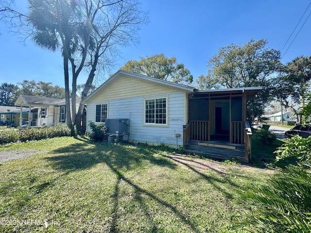 exterior space with a front yard and cooling unit