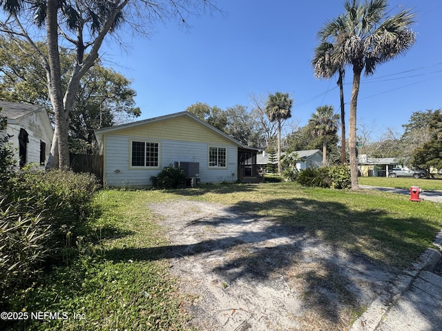 view of side of home with a lawn