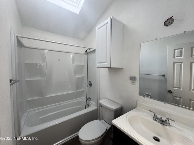 full bath featuring toilet, bathing tub / shower combination, vaulted ceiling with skylight, and vanity