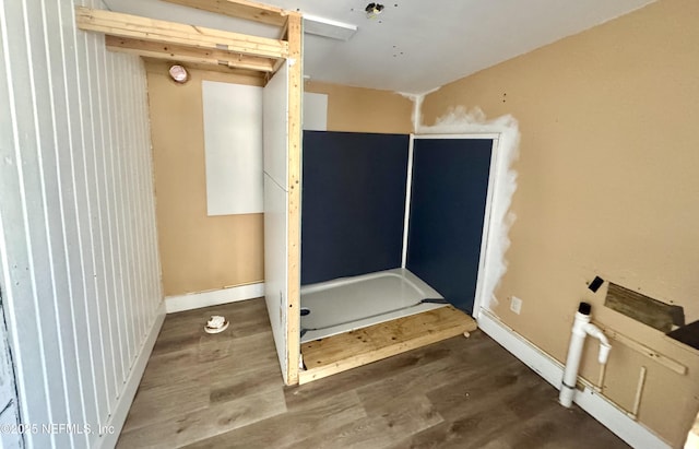 bathroom featuring baseboards and wood finished floors