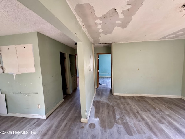 unfurnished room featuring baseboards and wood finished floors