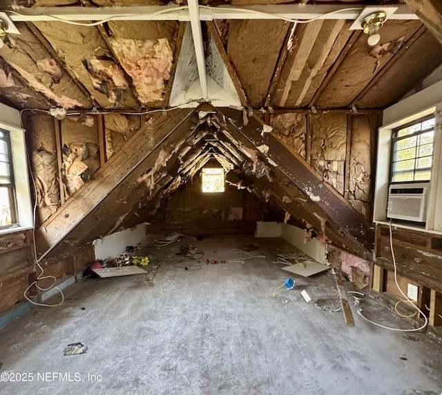 unfinished attic featuring plenty of natural light and cooling unit