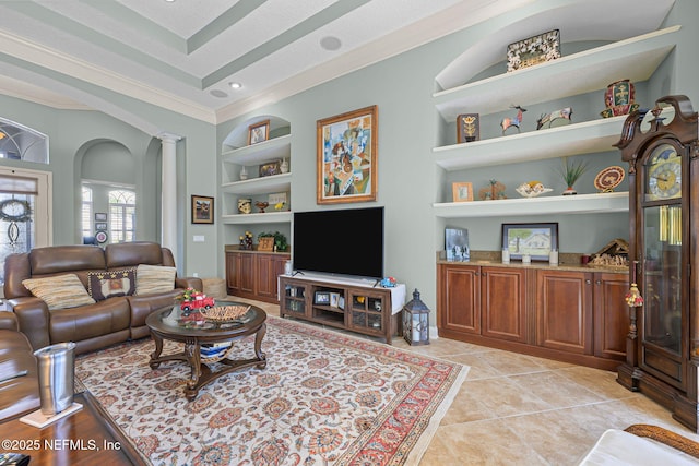 living room with built in features, light tile patterned flooring, ornamental molding, and ornate columns