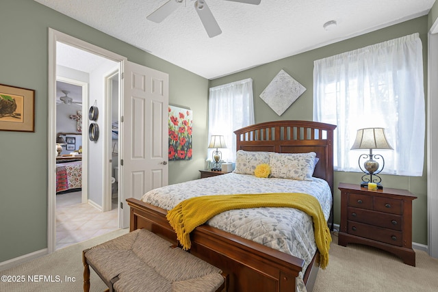 bedroom with a textured ceiling, ceiling fan, carpet flooring, and baseboards