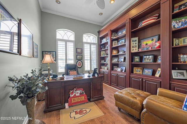 office area featuring crown molding, a ceiling fan, and wood finished floors